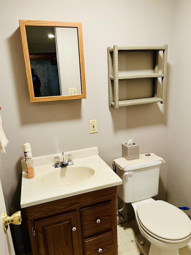 half bath featuring vanity and toilet