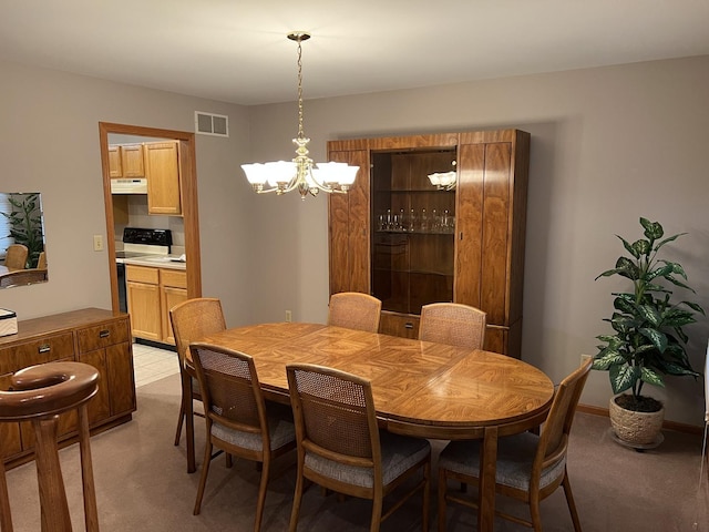 dining space with visible vents, baseboards, light colored carpet, and a chandelier