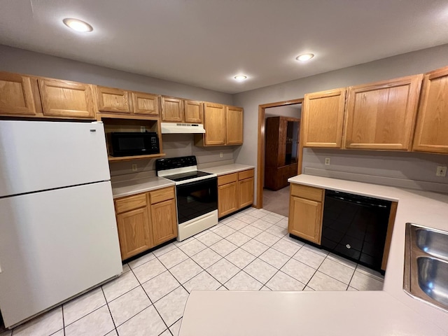 kitchen with black appliances, light tile patterned flooring, light countertops, and under cabinet range hood