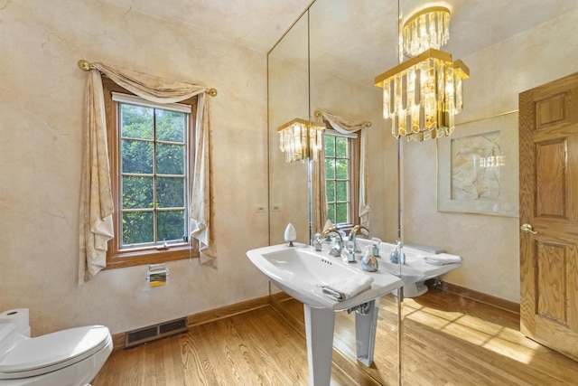 9 Forest Ln, South Barrington, IL 60010 - bathroom featuring a healthy amount of sunlight, wood finished floors, visible vents, and an inviting chandelier