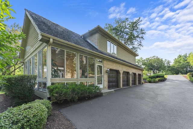 9 Forest Ln, South Barrington, IL 60010 - view of side of property with a garage, a sunroom, and driveway