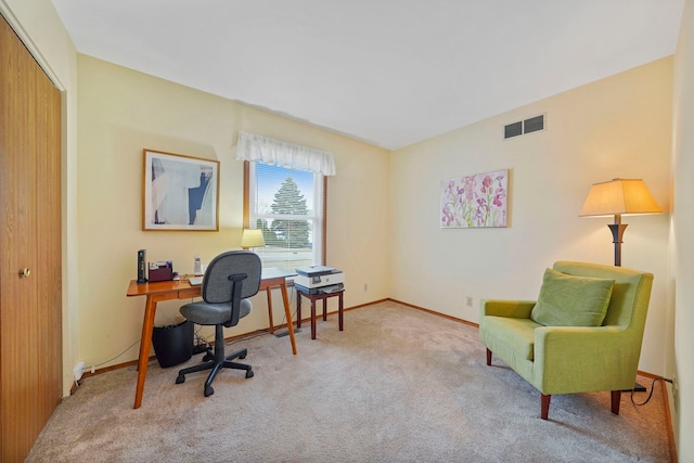 carpeted office space with visible vents and baseboards