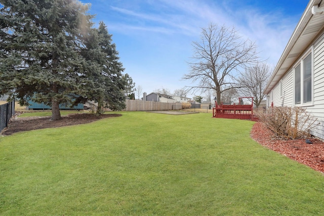 view of yard featuring a deck and fence