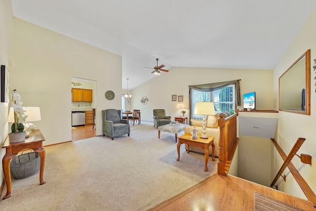 living area featuring lofted ceiling, light carpet, and ceiling fan