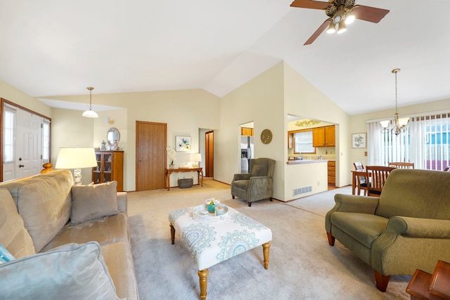 living area with light colored carpet, visible vents, vaulted ceiling, and ceiling fan with notable chandelier