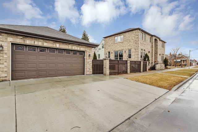 view of front of property with a garage, brick siding, a shingled roof, and fence