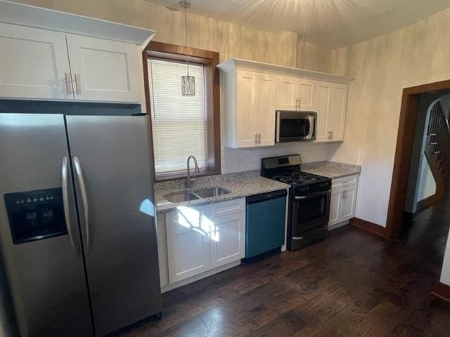 12120 S Parnell Ave, Chicago, IL 60628 - kitchen with appliances with stainless steel finishes, a sink, white cabinetry, light stone counters, and dark wood finished floors