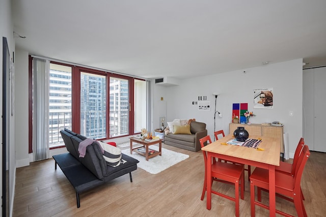 living room featuring light wood-type flooring and visible vents