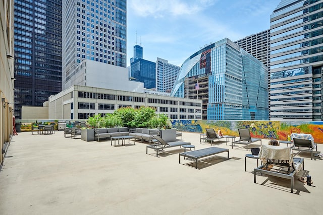 view of patio / terrace with a view of city and an outdoor living space