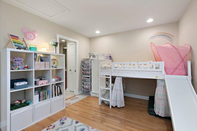 bedroom with wood finished floors and recessed lighting