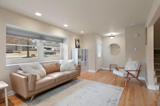 living room with light wood finished floors, stairway, recessed lighting, and baseboards