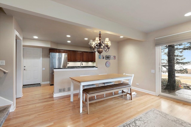 dining space with baseboards, light wood finished floors, visible vents, and recessed lighting