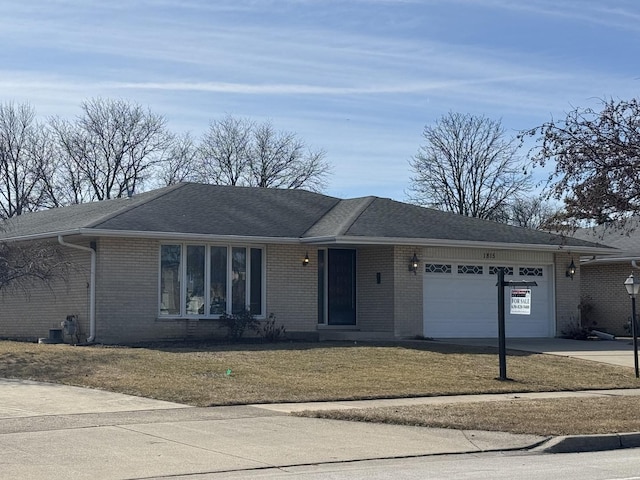 ranch-style home with a garage, brick siding, and a shingled roof