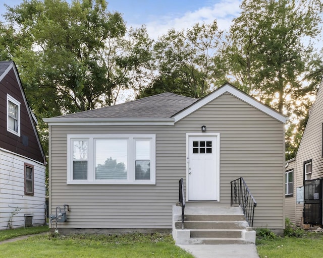 bungalow-style house with a shingled roof