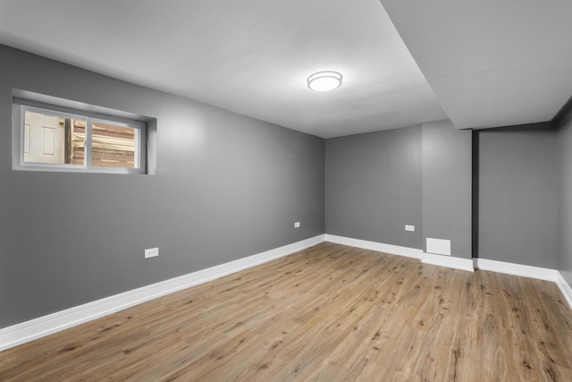 below grade area with light wood finished floors and baseboards