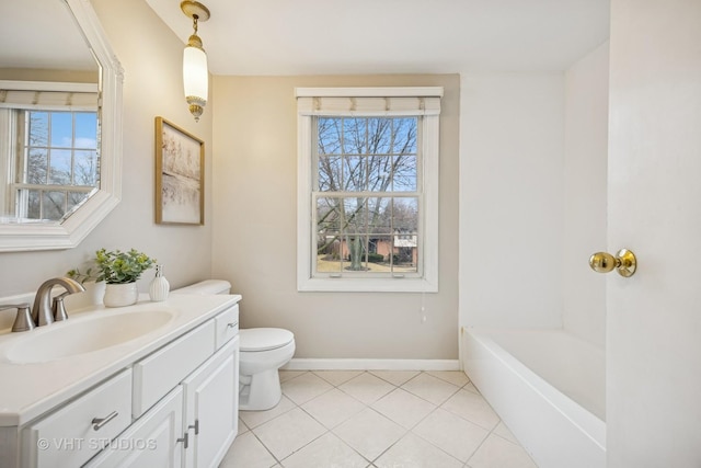 full bathroom featuring baseboards, toilet, a tub, tile patterned flooring, and vanity