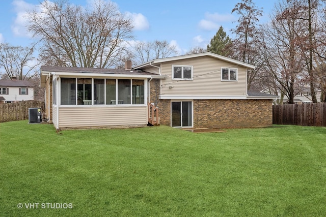 back of property featuring a chimney, a lawn, and brick siding