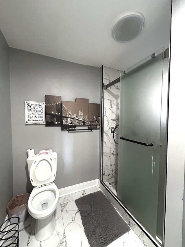 bathroom featuring baseboards, toilet, marble finish floor, and a stall shower