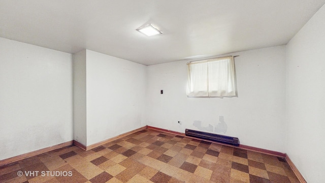 1222 Austin St, Evanston, IL 60202 - spare room featuring a baseboard heating unit and baseboards