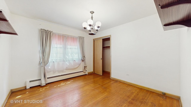 1222 Austin St, Evanston, IL 60202 - unfurnished room featuring a chandelier, hardwood / wood-style floors, and baseboards