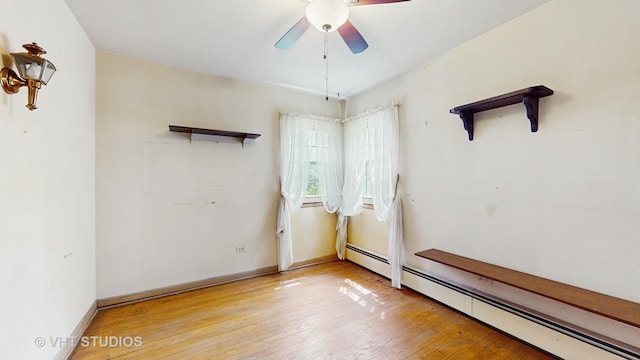 1222 Austin St, Evanston, IL 60202 - empty room featuring a baseboard heating unit, a ceiling fan, hardwood / wood-style floors, and baseboards