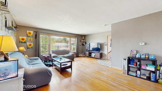 1222 Austin St, Evanston, IL 60202 - living area with light wood-style floors and a baseboard heating unit