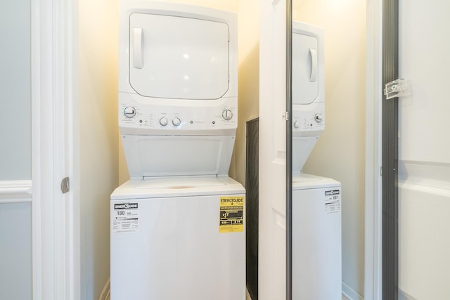 clothes washing area featuring laundry area and stacked washer / dryer