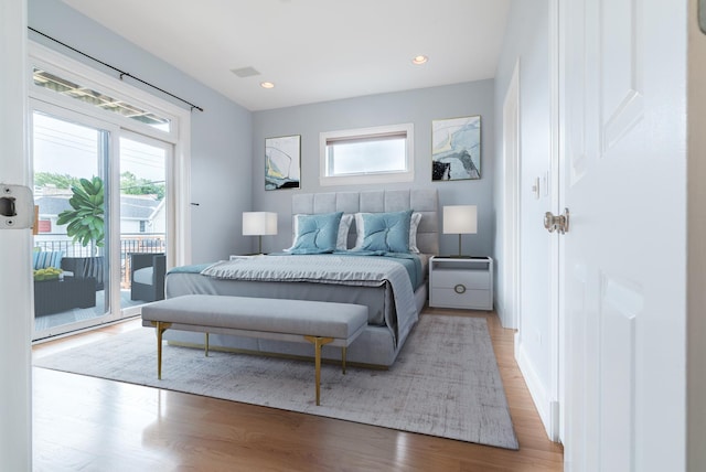 bedroom featuring access to exterior, recessed lighting, wood finished floors, and visible vents