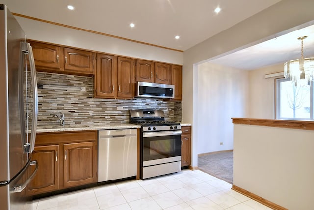 kitchen featuring stainless steel appliances, brown cabinetry, a sink, and backsplash