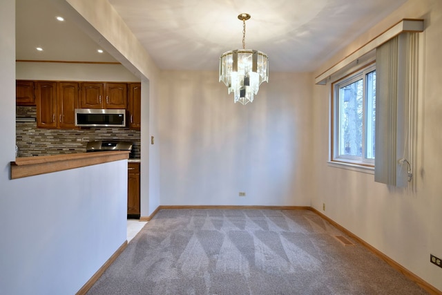 unfurnished dining area featuring light carpet, baseboards, visible vents, a chandelier, and recessed lighting