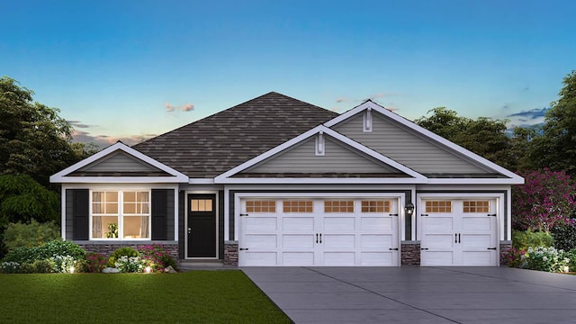 view of front of property with a garage, driveway, a shingled roof, stone siding, and a yard