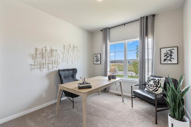 carpeted home office featuring baseboards