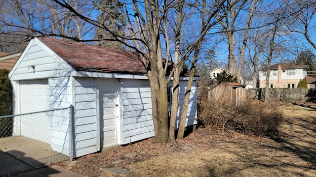 view of outbuilding featuring an outdoor structure and fence