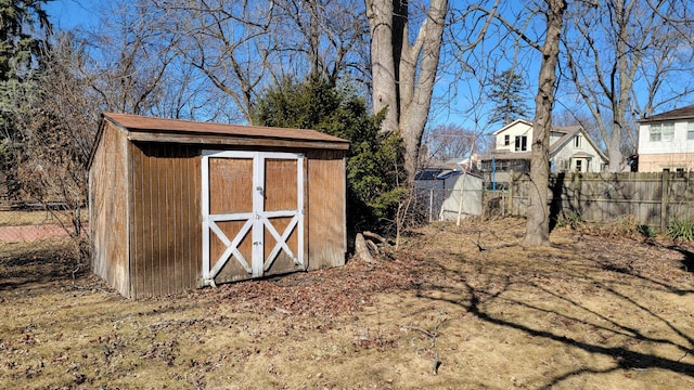 view of shed featuring fence