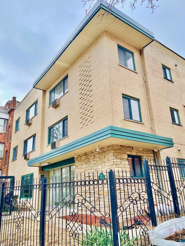 view of building exterior with a fenced front yard