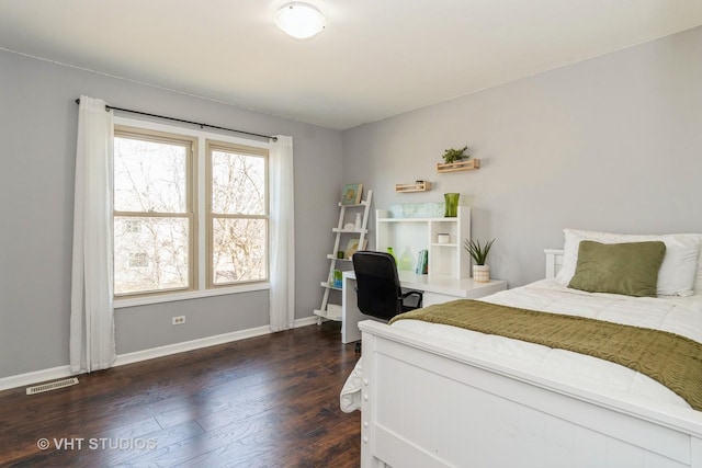 bedroom with visible vents, baseboards, and dark wood-style flooring