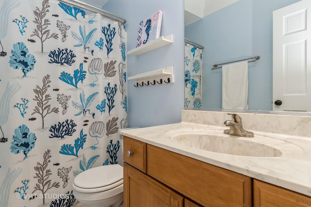 bathroom featuring a shower with shower curtain, toilet, and vanity