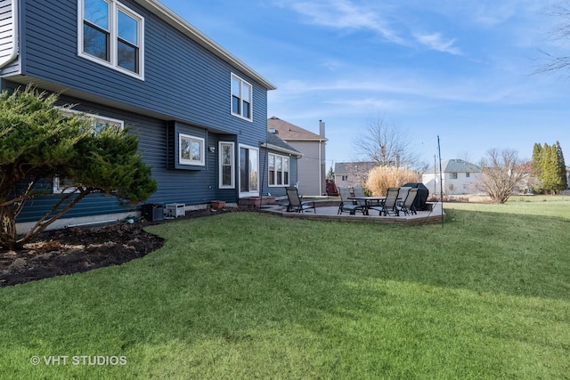 back of property featuring a lawn and a patio