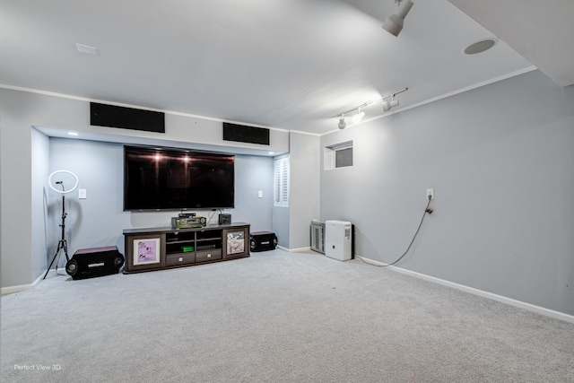 living room with ornamental molding, carpet, rail lighting, and baseboards