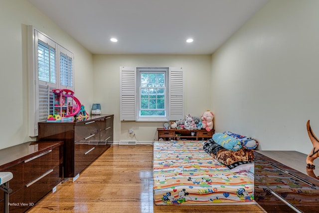 game room with baseboards, light wood finished floors, and recessed lighting