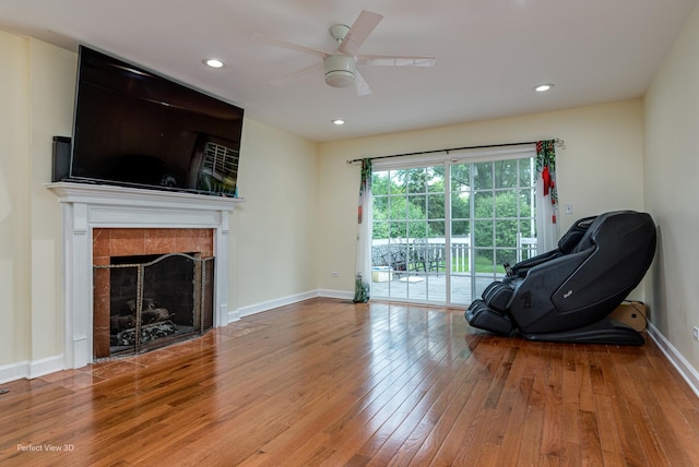 sitting room with a fireplace, baseboards, hardwood / wood-style floors, and recessed lighting