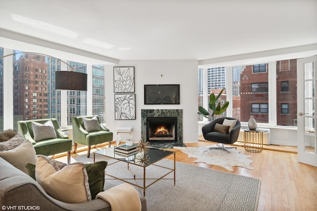 living area with wood finished floors and a high end fireplace