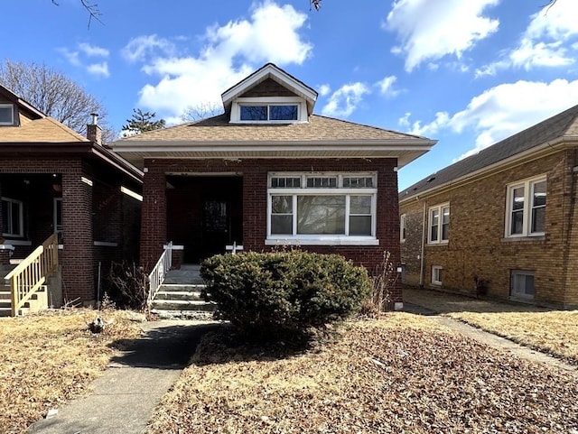 bungalow-style house featuring a porch and brick siding