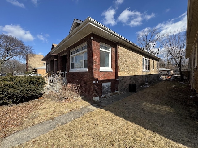 view of side of home featuring brick siding