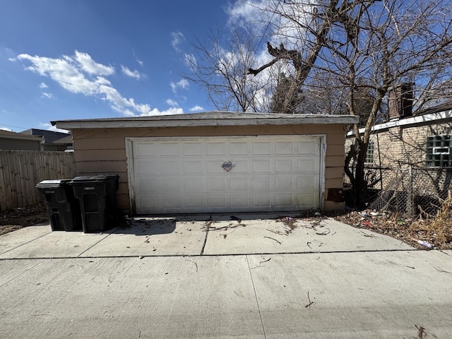 detached garage featuring fence