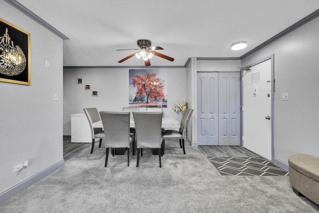 dining space featuring ceiling fan, baseboards, crown molding, and carpet flooring