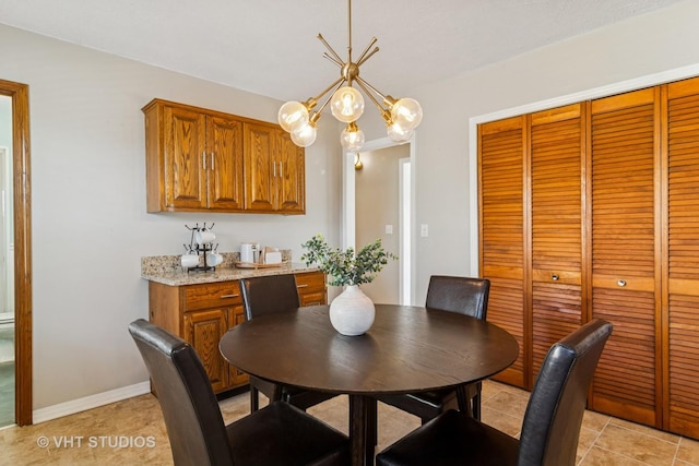 dining space with baseboards and an inviting chandelier