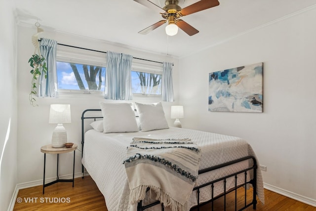 bedroom featuring ceiling fan, baseboards, and wood finished floors