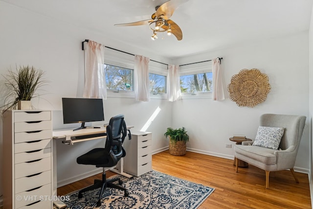 office space with ceiling fan, baseboards, and light wood-style flooring