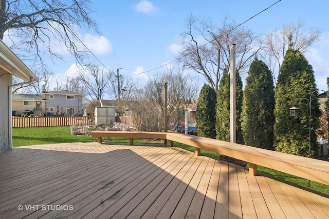 deck featuring a yard and fence